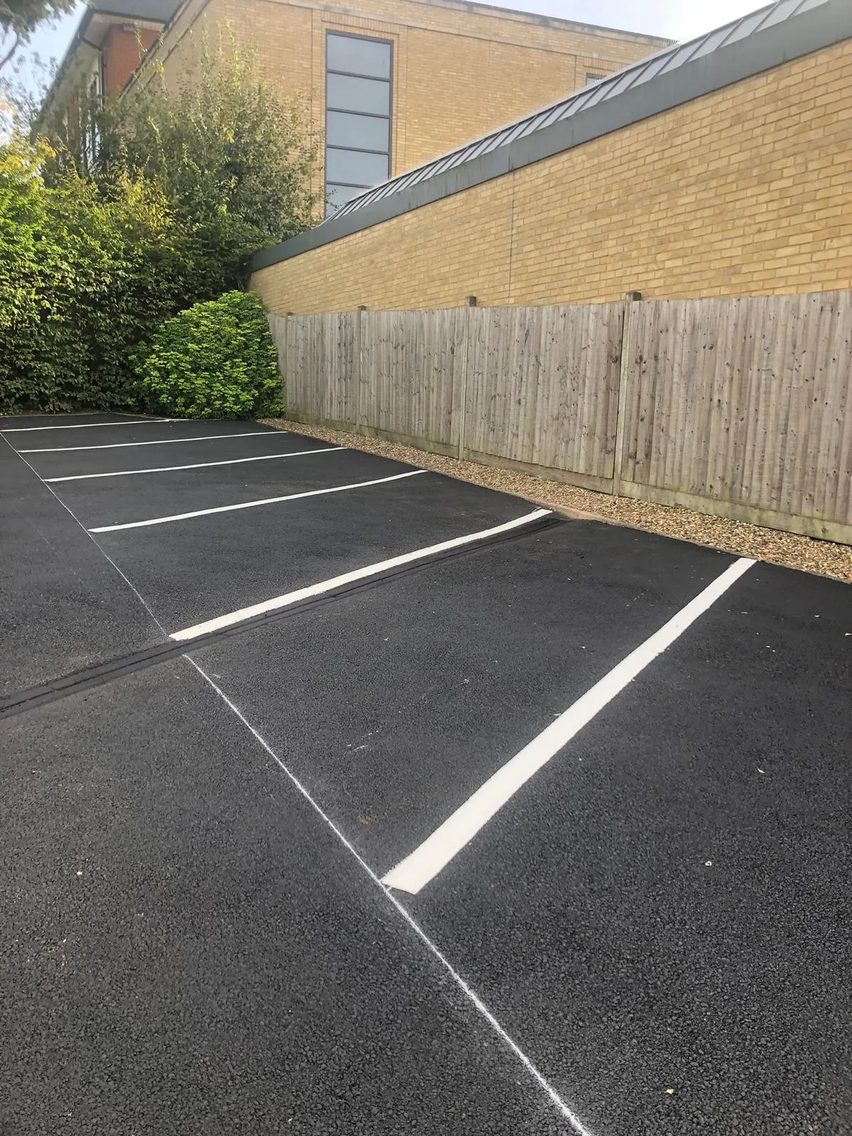 Newly marked parking bays on a resurfaced car park