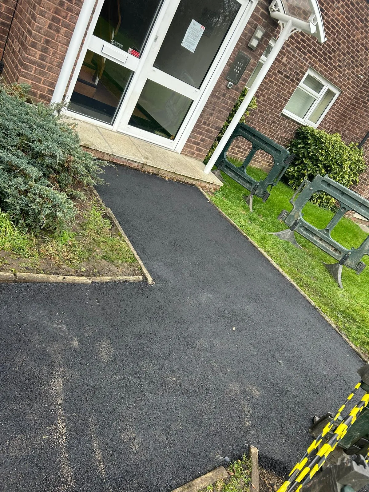 A resurfaced path running alongside a building