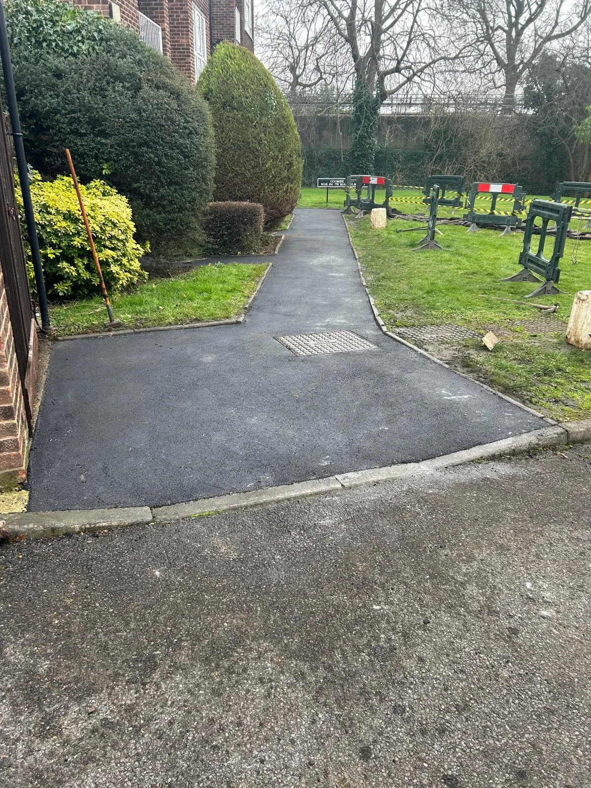 A newly surfaced pathway through a landscaped area