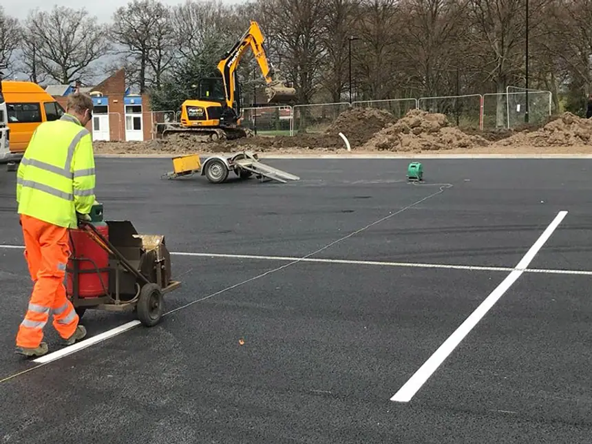 Fresh line marking across a resurfaced car park