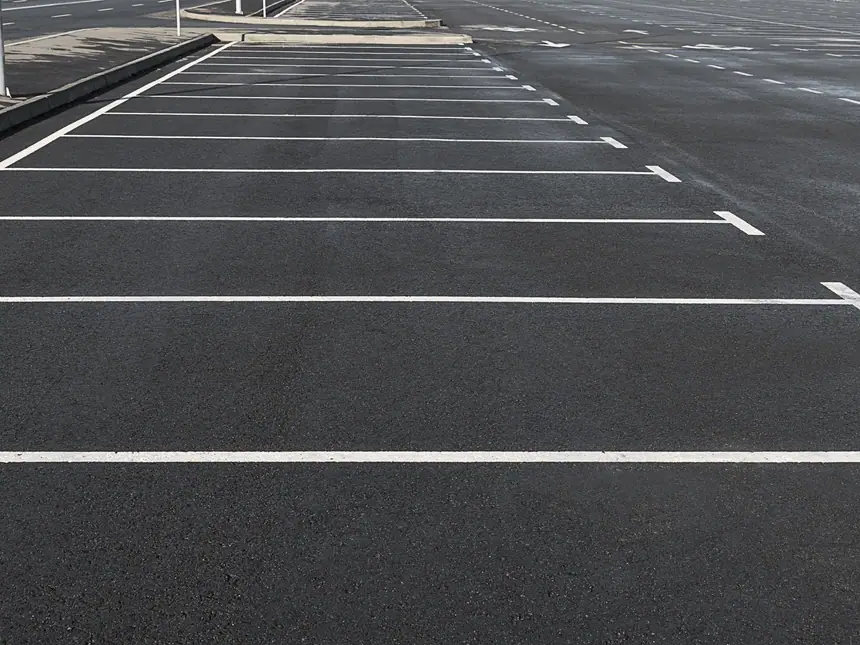 Empty parking bays on a resurfaced surface