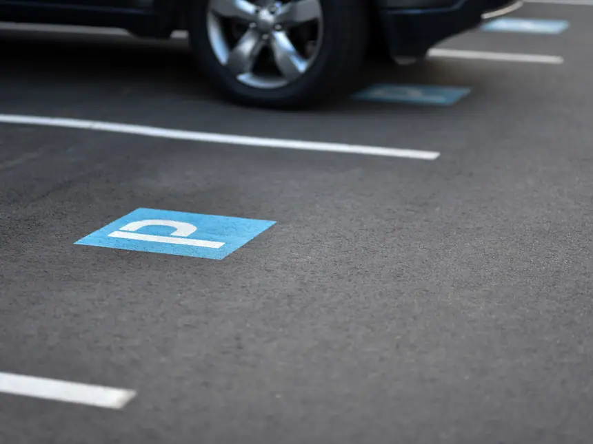 A blue disabled bay marking on new tarmac