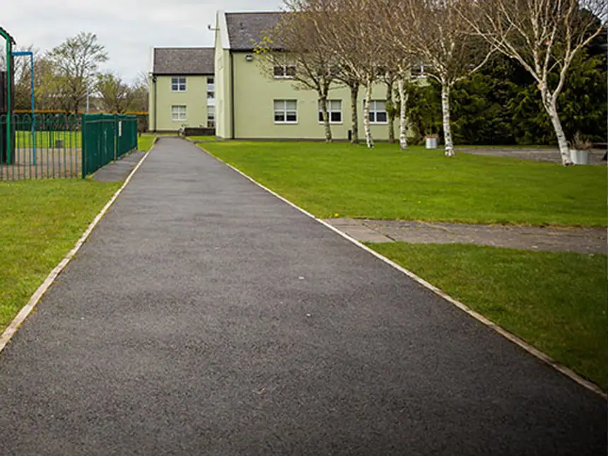 A resurfaced path running between buildings