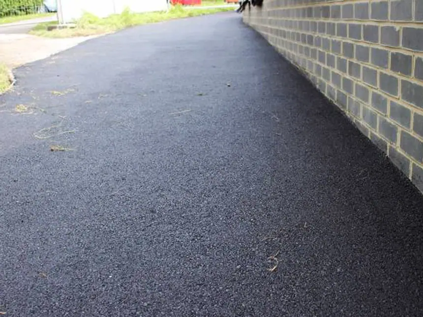 A tarmac path curving through a landscaped area