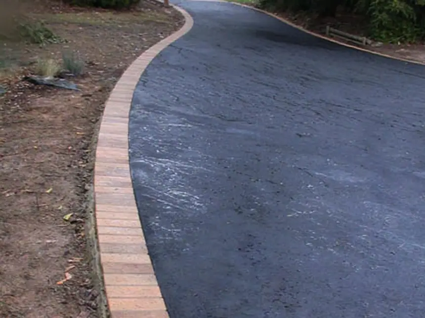 A newly surfaced footpath beside a wall