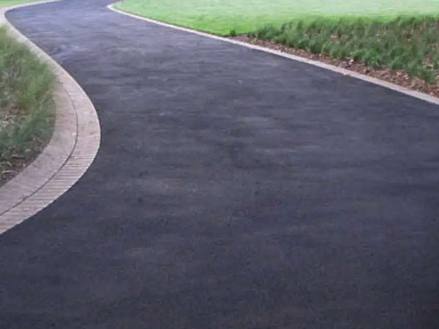 A tarmac path with a block paved edging