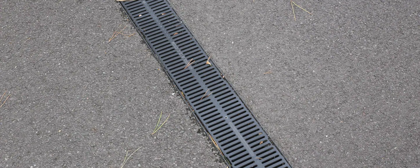 A channel drain along a resurfaced path — Path Resurfacing in Halstead by Meads Resurfacing