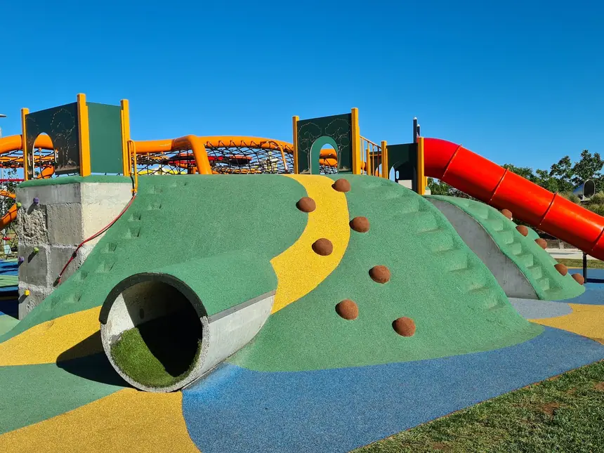 A school playground with coloured play surfacing
