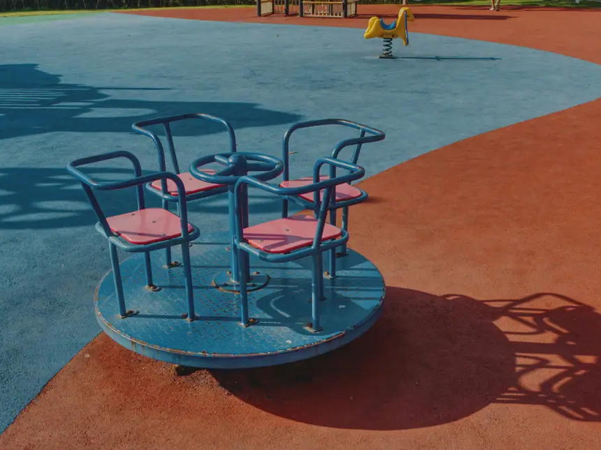 A coloured play surface in a public play area