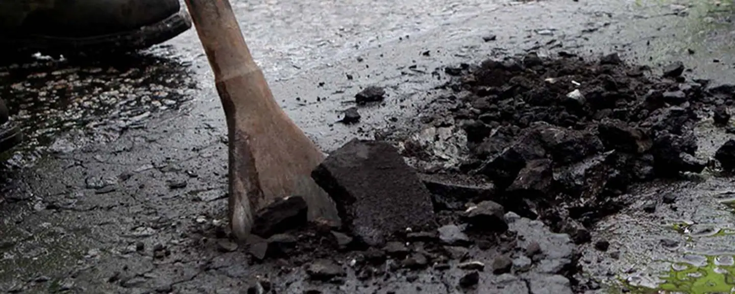 A plate compactor finishing a pothole repair — Pothole Repairs in Hammersmith by Meads Resurfacing