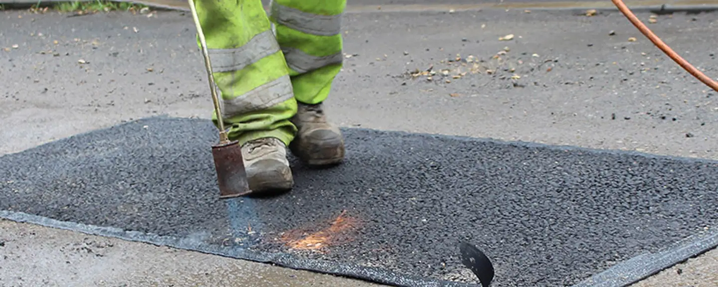 Broken tarmac being lifted out before filling — Pothole Repairs in Orpington by Meads Resurfacing
