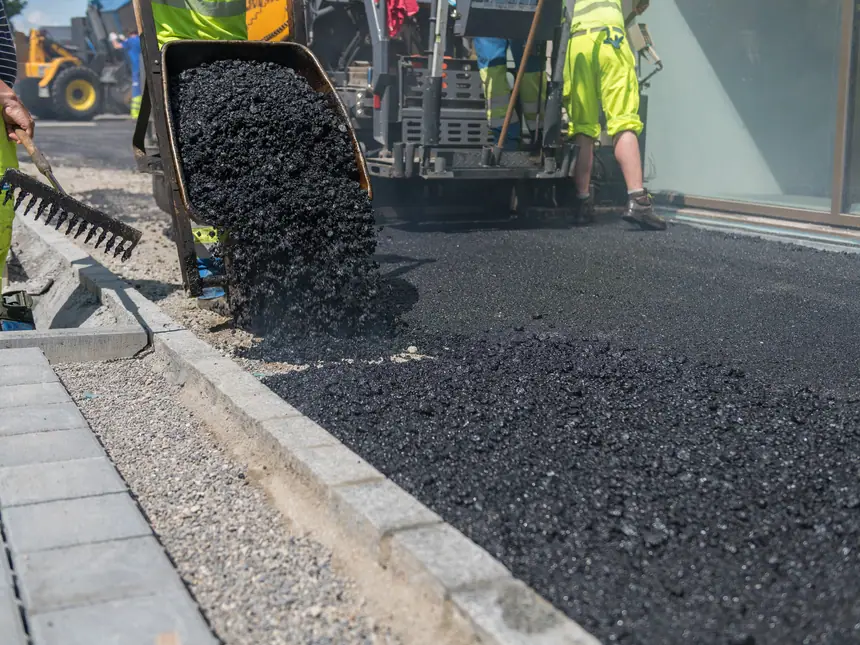 A new asphalt course laid up to the kerb line