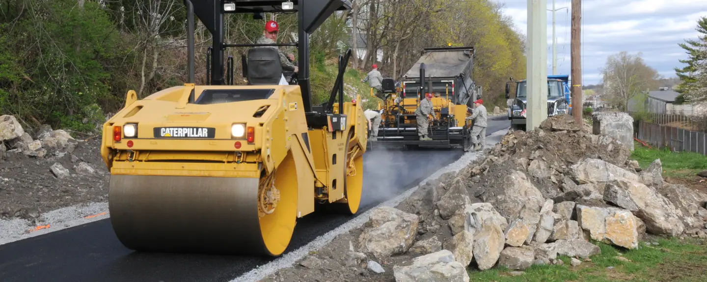 A roller and paver resurfacing a rural road — Road Resurfacing in Brixton by Meads Resurfacing