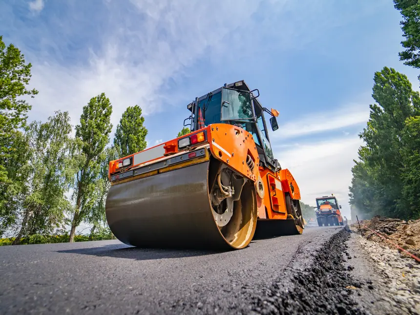 Two rollers compacting a newly surfaced road