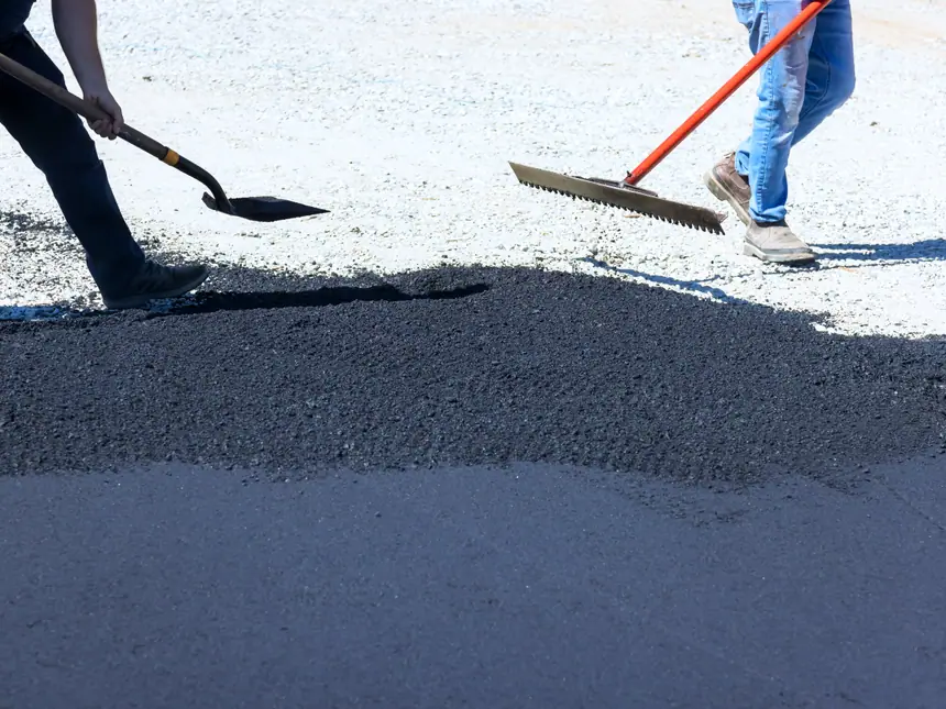 An operative raking the edge of a fresh surface