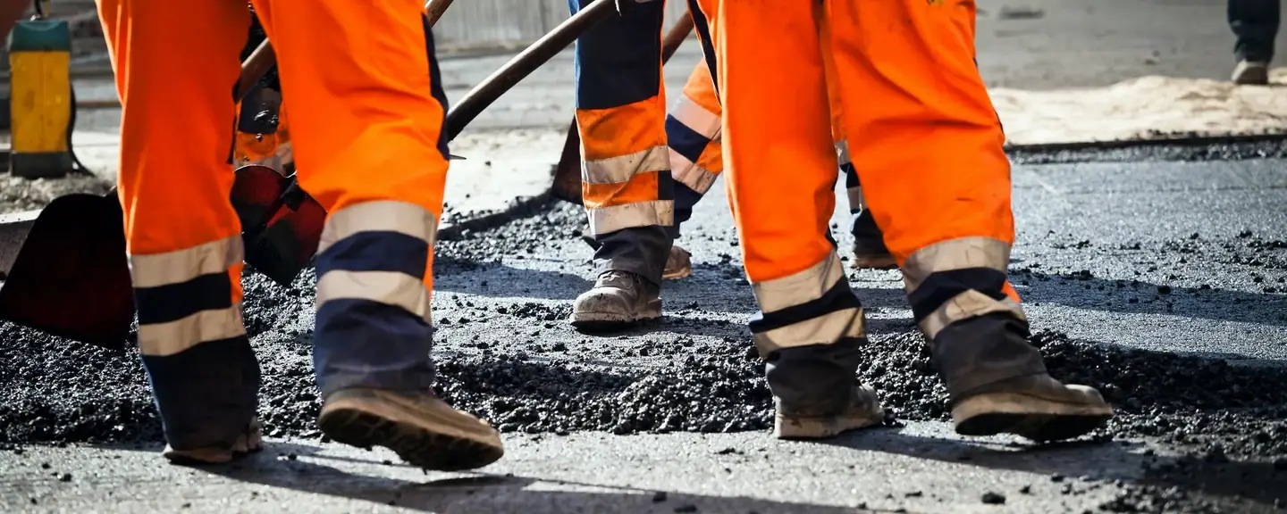 A team spreading tarmacadam across a carriageway — Road Resurfacing in Langley by Meads Resurfacing