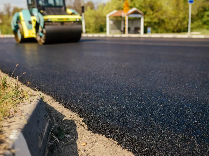 A roller working fresh hot asphalt