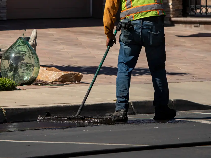 Sealant spread with a long-handled squeegee