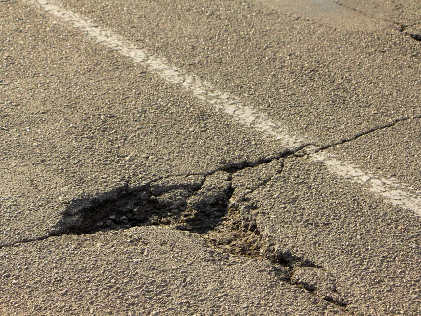 Deteriorated asphalt breaking up at the surface