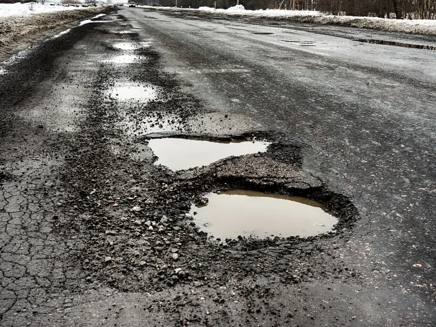 Surface cracking spreading across asphalt