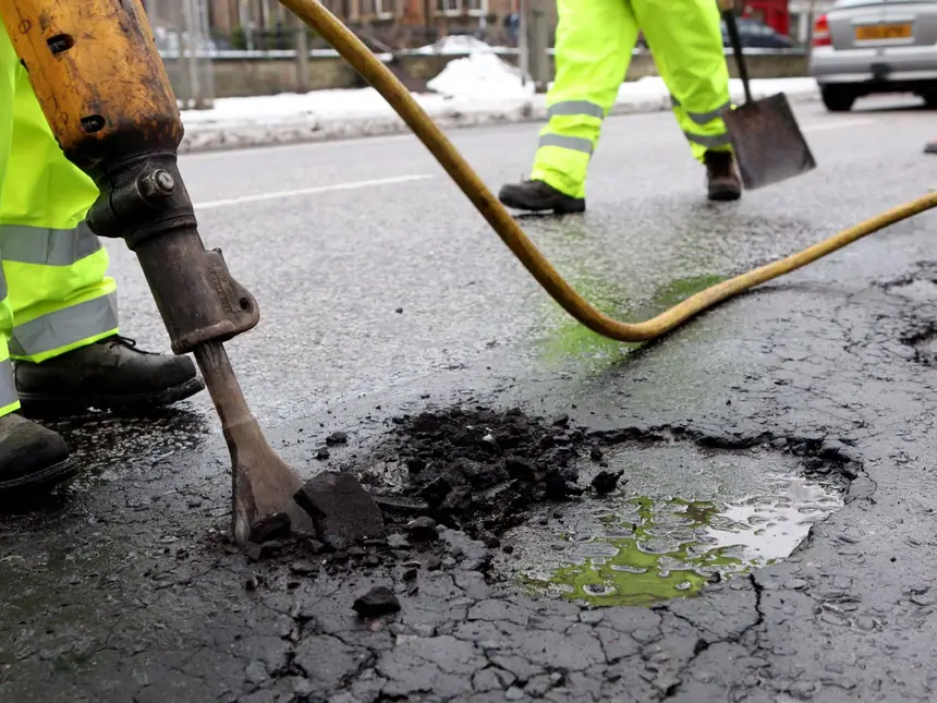 A hi-vis operative attending a road repair