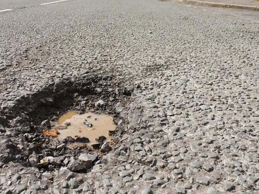 A repaired section of asphalt road