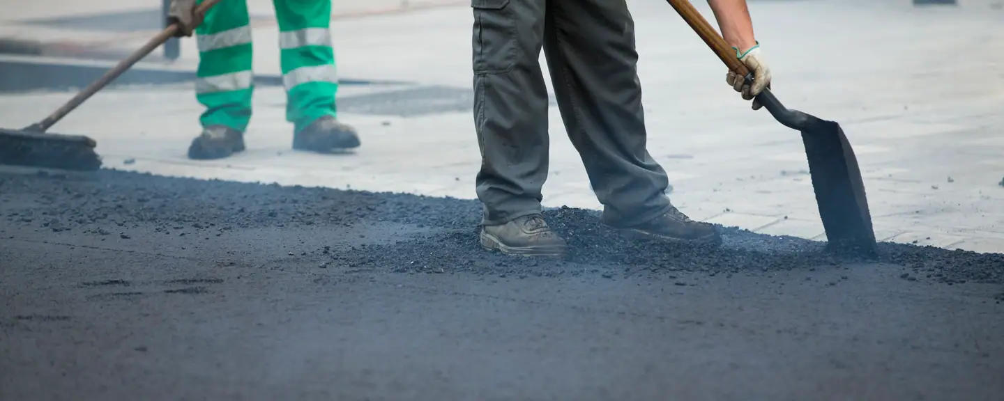 Two contractors shovelling tarmac — Tarmac Contractors in Langley by Meads Resurfacing