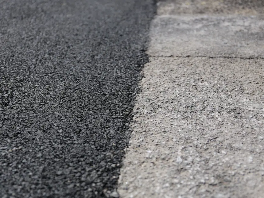 A tarmac surface with a defined white edge line
