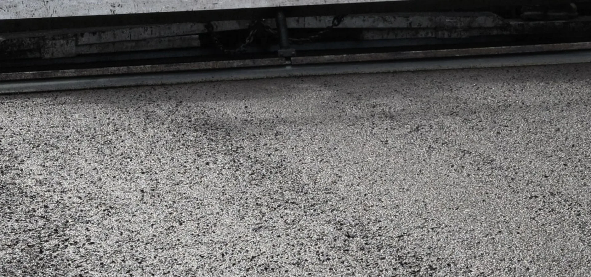 Tarmac road surfacing being laid by the Meads Resurfacing team